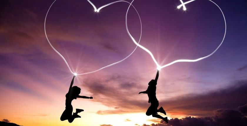 two people jumping with hearts